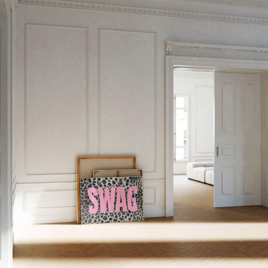 Pink SWAG animal print wall art layered with canvases on parquet flooring