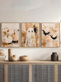 Neutral Halloween art trio above a woven-door cabinet with ceramic vases