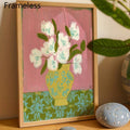 Close view of white painted flowers and green leaves with textured pink background