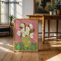 Framed flower vase canvas in bright room beside wood table and houseplants