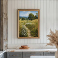Gold framed rural wildflower landscape print styled in a rustic kitchen