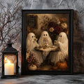 Black framed ghost tea party artwork beside a lantern and candle
