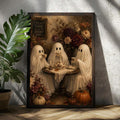 Black framed ghost tea party wall art beside a houseplant