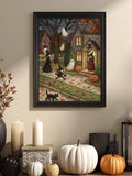 Black framed Halloween village artwork displayed with candles and pumpkins