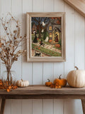 Cream framed witch and ghost village poster on a white paneled wall