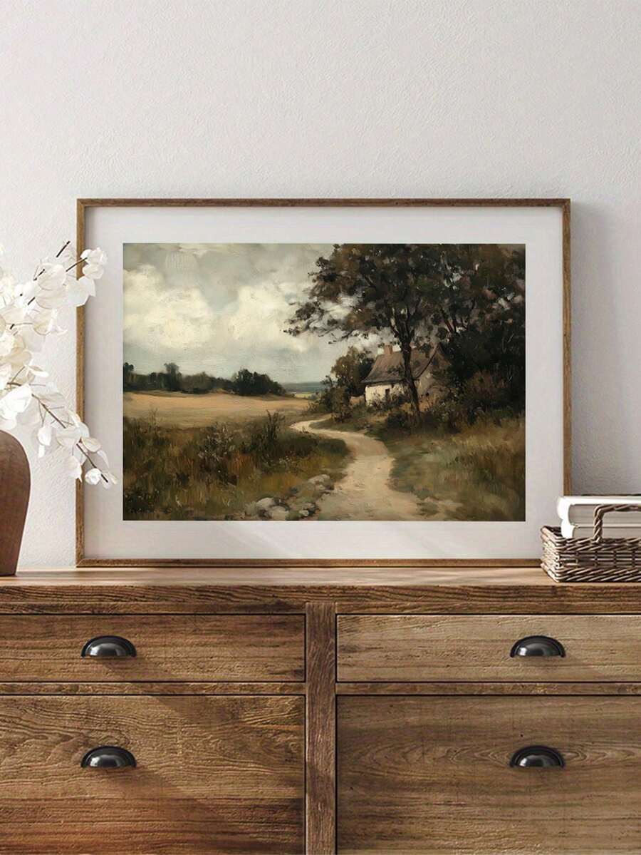 Country cottage painting resting on a rustic dresser