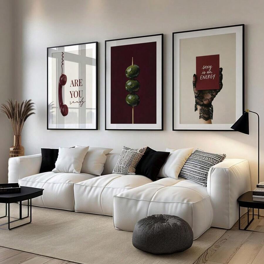 Three-piece burgundy and olive gallery wall set above a modern white sectional