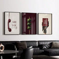 Green olive skewer poster in a slim black frame above a black leather sofa