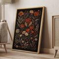 Rust orange floral wall art in a wood frame beside cane furniture