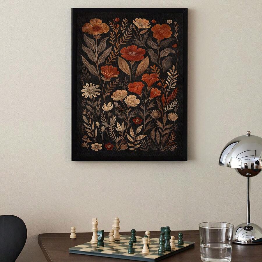 Terracotta wildflower poster in a black frame above a desk