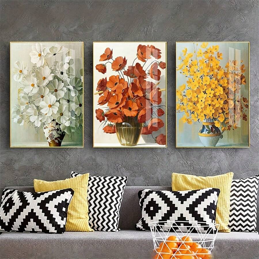Unframed set of rust, white, and yellow vase bouquet prints on a textured wall