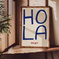 Hand-painted navy HOLA lettering with red amigos text