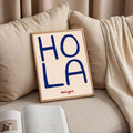 Spanish greeting wall art styled beside plants and wood decor