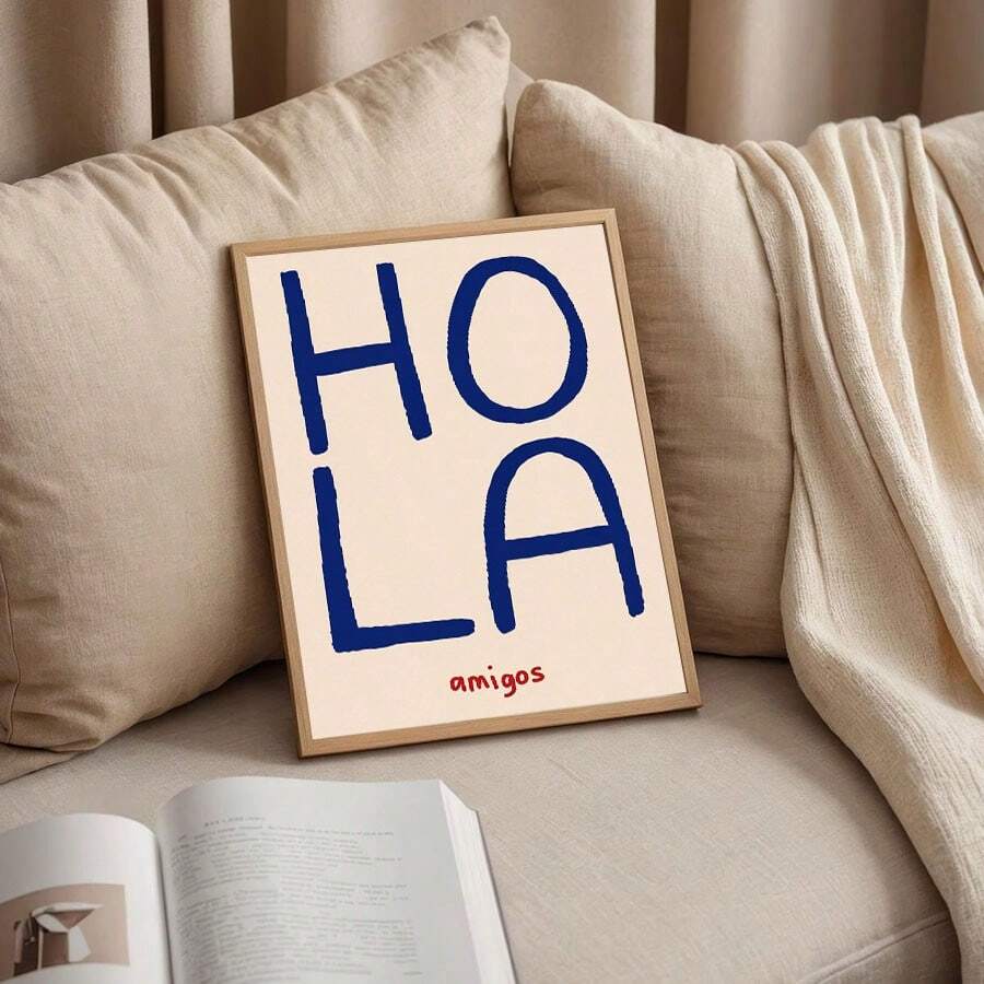 Spanish greeting wall art styled beside plants and wood decor