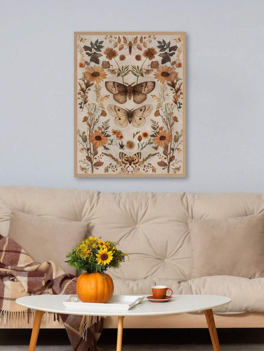 Framed moth and sunflower print above a cozy tufted sofa