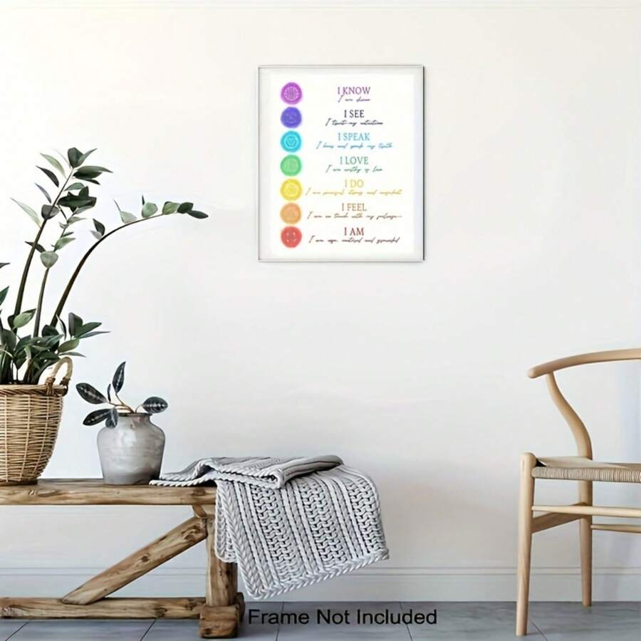 Unframed chakra affirmation poster above a console table with plants and a chair