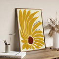 Natural wood-framed yellow sunflower motivational print displayed on a wooden desk