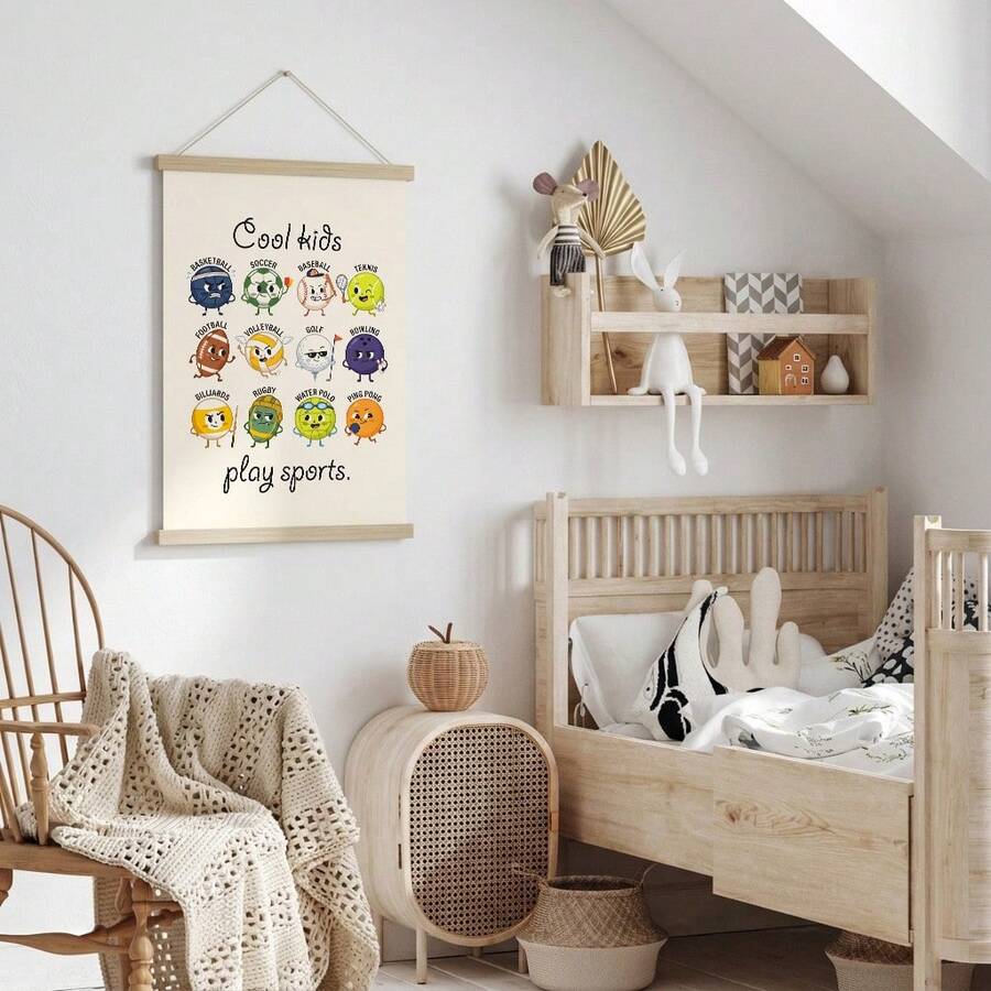 Sports themed children’s canvas hanging beside a nursery bed and rocking chair