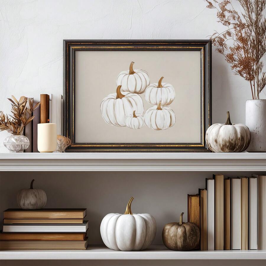 Dark-framed white pumpkin canvas print styled among books candles and seasonal gourds