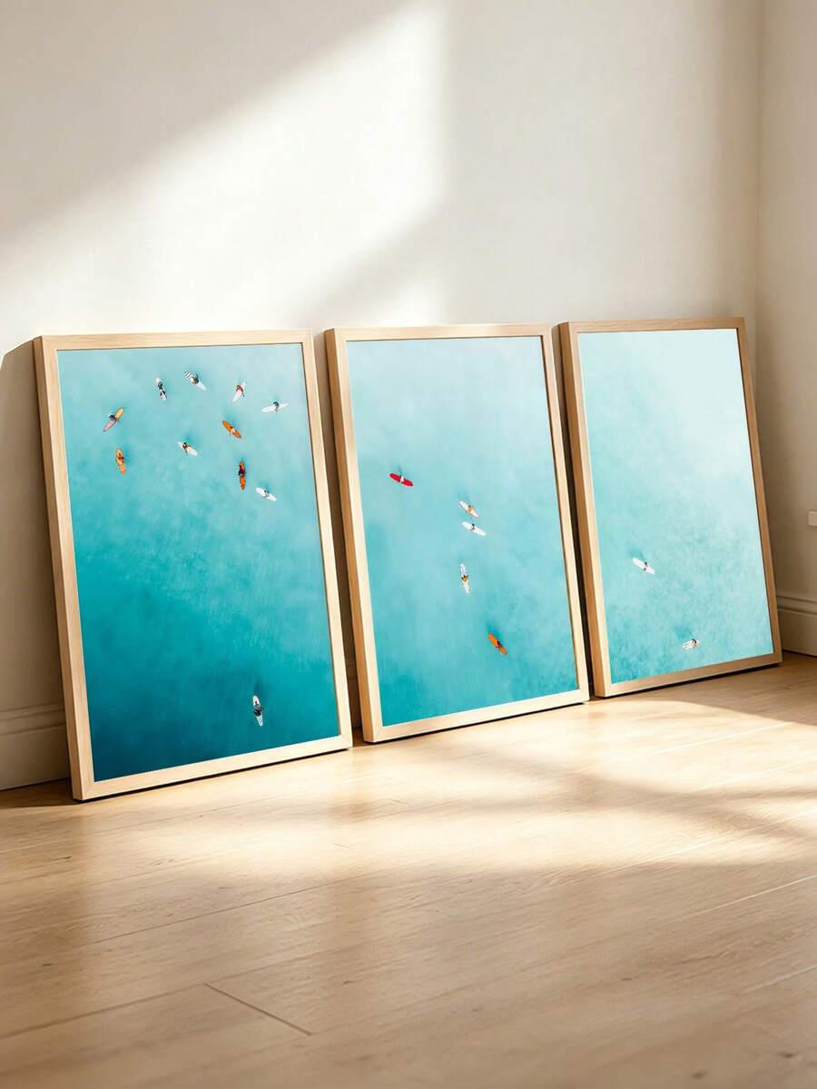 Framed teal ocean surf poster triptych displayed in a sunlit minimalist interior