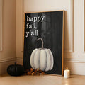 Framed happy fall y’all pumpkin canvas print in a paneled room with autumn candles