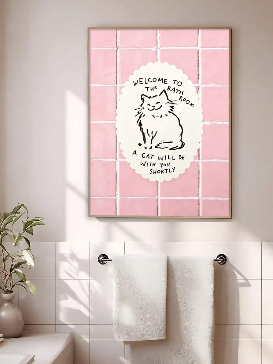 Framed pink cat bathroom sign beside white towels in a bright bathroom