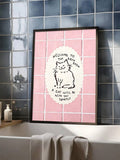 Pink cat bathroom wall art displayed above a bathtub on dark tiles