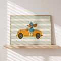 Unframed dog and orange racing car print beside a living room sofa