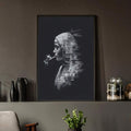 Black framed smoking woman portrait displayed on a dark interior shelf