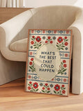 Folk art quote print styled beside a cream lounge chair