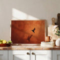 Framed bird wall art styled beside kitchen décor