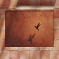 Terracotta Southwestern bird poster displayed in a dining room