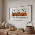 Room view of framed pumpkin Halloween wall art above a sideboard