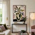 Framed abstract plant canvas displayed above a living room console