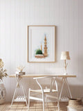 Framed green dome mosque watercolor poster above a home office desk