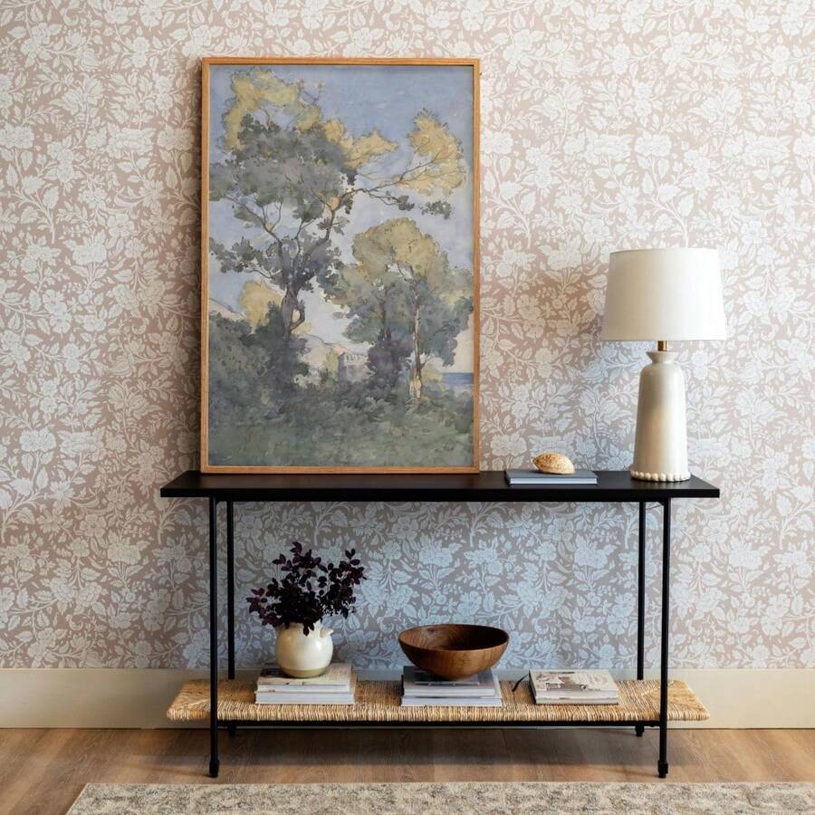 Watercolor tree canvas poster styled on a console against botanical wallpaper