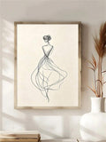 Minimal female figure line art in a light wood frame on a shelf