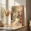 Courtyard artwork leaning on a wooden bedroom console beside pampas grass