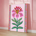 Large framed lily print leaning against a pink paneled wall