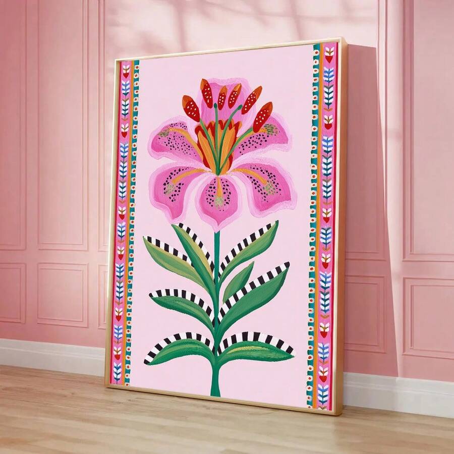 Large framed lily print leaning against a pink paneled wall