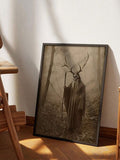 Gothic forest canvas poster in a gold frame leaning against a paneled cream wall