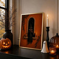 Framed witch reading art above a chair with ghost blanket