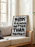Large regret quote artwork leaning near a neutral sofa and plant