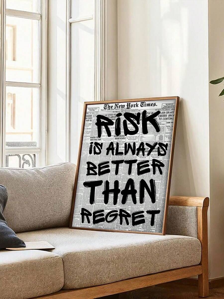 Large regret quote artwork leaning near a neutral sofa and plant