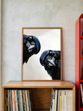 Raven and crow canvas poster styled above a bookshelf with modern decor