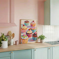 Cupcake food art poster in a wood frame above a kitchen counter with jars