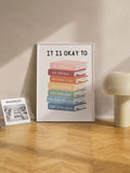 Book stack quote artwork leaning on a wooden floor beside a small print