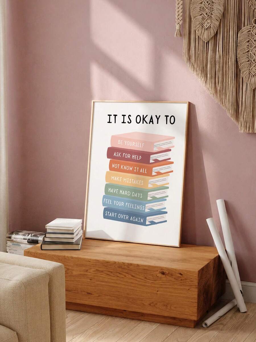 Framed colorful book stack poster styled on a pink-toned shelf