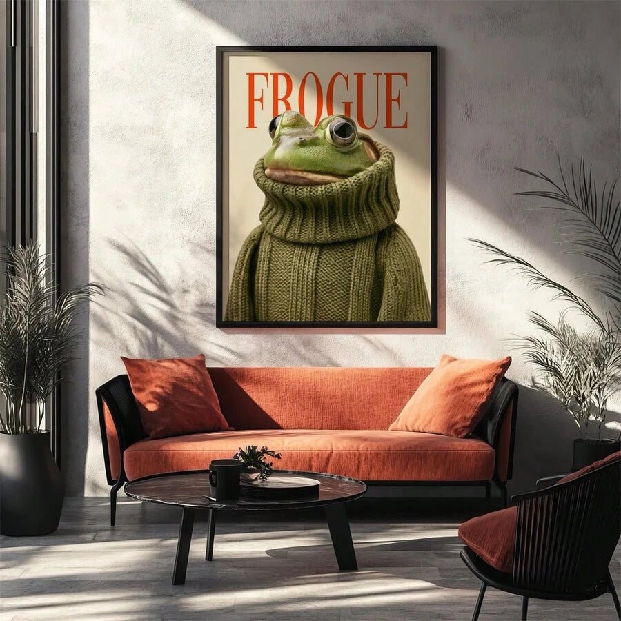Black-framed Frogue fashion frog poster displayed above an orange living room sofa