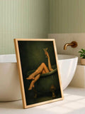 Framed bathtub cocktail wall art styled against soft green bathroom tiles and brass fixtures